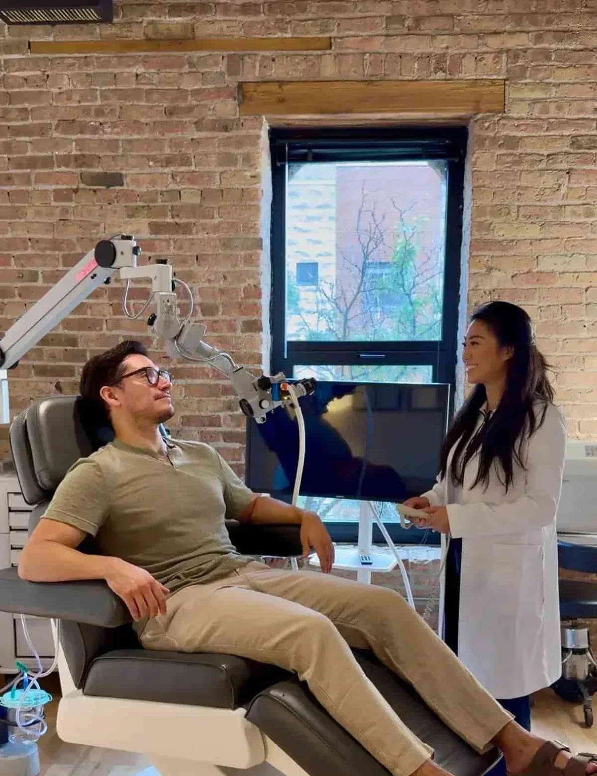 Patient relaxing in treatment chair while the CERA Ear Clinic provider prepares for ear cleaning.